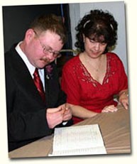 Glenn and Janet signing the register