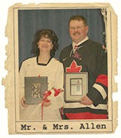 Janet and Glenn holding photos of their deceased father and mother